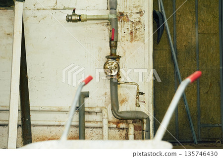 Plumbing in basement.Water valve shutting off the water tap Plumbing in basement.Water valve shutting off the water tap 135746430