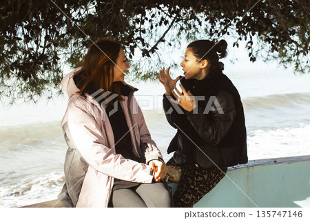 two girls friends walking together outside, lifestyle people concept two girls friends walking together outside, lifestyle people concept 135747146