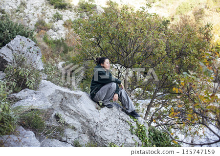 young pretty brunette girl hiking to waterfall, lifestyle people concept young pretty brunette girl hiking to waterfall, lifestyle people concept 135747159