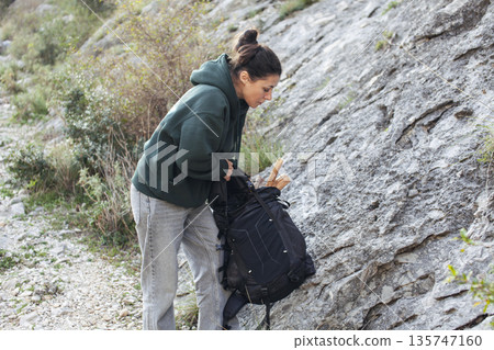 young pretty brunette girl hiking to waterfall, lifestyle people concept 135747160