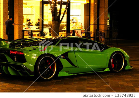 Supercar Lamborghini luxury exotic car illumination shining in the city at night Supercar Lamborghini luxury exotic car illumination shining in the city at night 135748925