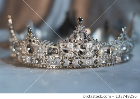 White crown with crystals, diamonds on grey background. White crown with crystals, diamonds on grey background. 135749256