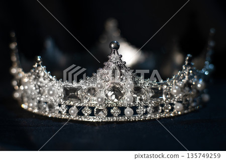 White golden crown with crystals, diamonds on black background. White golden crown with crystals, diamonds on black background. 135749259