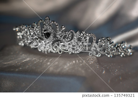 White crown with crystals, diamonds on grey background. White crown with crystals, diamonds on grey background. 135749321
