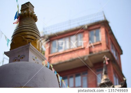 A small stupa and Buddha's eye blending into the city of Nepal 135749989
