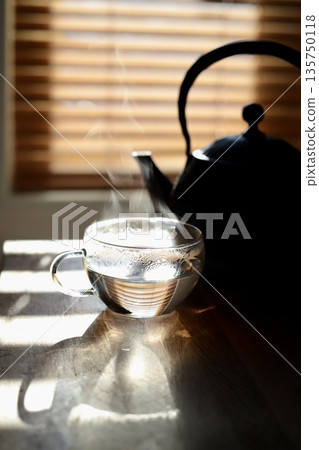 Hot water brewed in an iron kettle for first thing in the morning Hot water brewed in an iron kettle for first thing in the morning 135750118