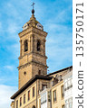 Historic clock tower in the old center of Vitoria Gasteiz, Basque Country, Spain. Bright blue sky 135750171