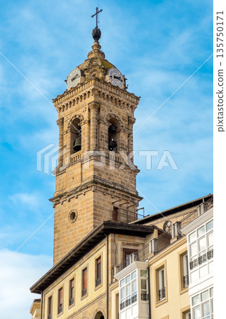 Historic clock tower in the old center of Vitoria Gasteiz, Basque Country, Spain. Bright blue sky 135750171