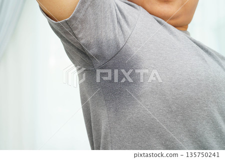 Sweaty underarms, Asian woman with sweat on clothes under armpit. Sweaty underarms, Asian woman with sweat on clothes under armpit. 135750241