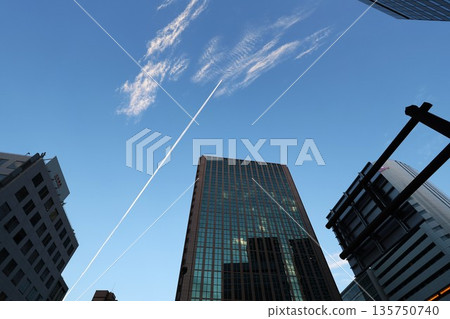 The skyscrapers of Umeda, Osaka, and the contrails visible above them 135750740