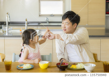 A happy family at the dinner table 135750940