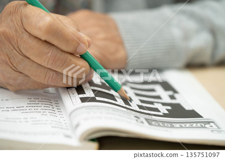 Bangkok, Thailand - May 15, 2022 elderly woman playing sudoku puzzle game. 135751097