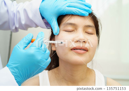 Asian woman receiving filler beauty injection. Asian woman receiving filler beauty injection. 135751153