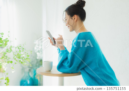 A woman watching a smartphone 135751155