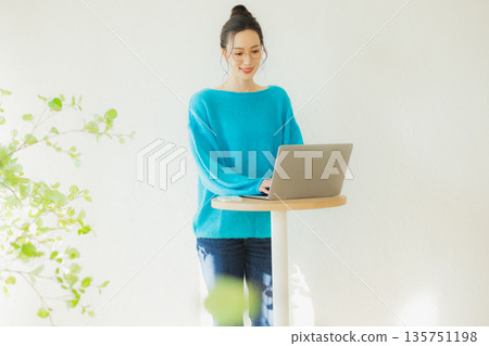 A woman using a computer 135751198