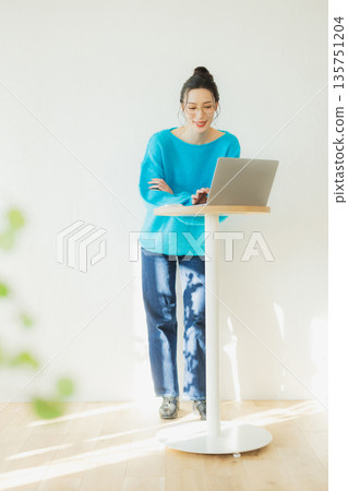 A woman using a computer A woman using a computer 135751204
