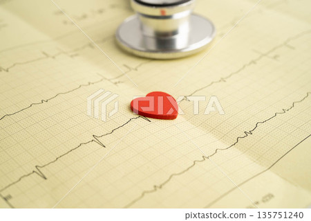 Stethoscope on electrocardiogram ECG, heart wave, heart attack, cardiogram report. Stethoscope on electrocardiogram ECG, heart wave, heart attack, cardiogram report. 135751240
