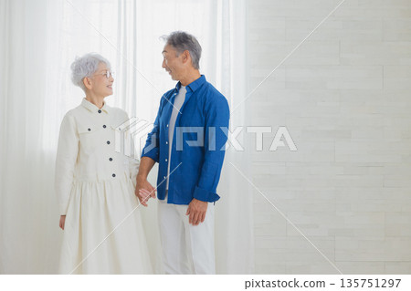 Smiling senior couple holding hands 135751297