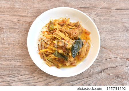 spicy stir fried bamboo shoot and chicken with curry on plate spicy stir fried bamboo shoot and chicken with curry on plate 135751392