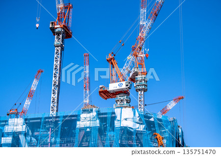 New landscape of Tokyo cityscape in Japan. TOKYO TORCH Huge steel structure and cranes in Otemachi. To the future 135751470
