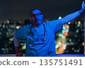 Male medic standing on rooftop city at night 135751491