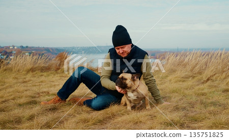 A Heartwarming Moment Between a Man and His Dog Bonding in a Scenic Landscape, Surrounded by Nature's Beauty, Embracing Friendship, Joy, and the Serenity of the Great Outdoors A Heartwarming Moment Between a Man and His Dog Bonding in a Scenic Landscape, Surrounded by Nature's Beauty, Embracing Friendship, Joy, and the Serenity of the Great Outdoors 135751825