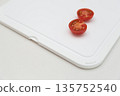 Cut tomatoes on a cutting board 135752540