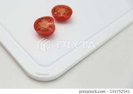 Cut tomatoes on a cutting board Cut tomatoes on a cutting board 135752541