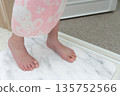 A girl wiping her feet on a diatomaceous earth bath mat 135752566