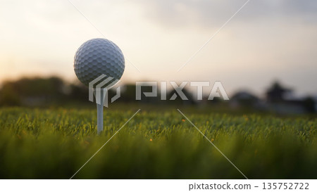 Golf ball on tee in a beautiful golf course with morning sunshine. 135752722