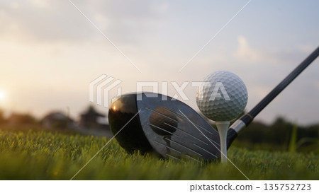Golf clubs and balls on a green lawn in a beautiful golf course with morning sunshine. 135752723