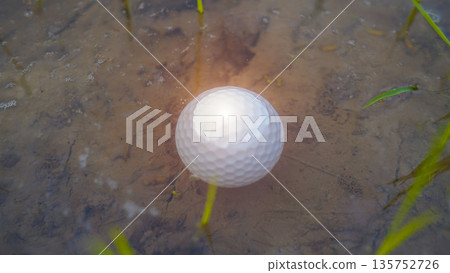 White golf ball falls into the water one of the obstacles to playing golf White golf ball falls into the water one of the obstacles to playing golf 135752726