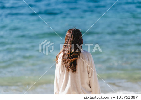 Woman taking pictures at the seaside Woman taking pictures at the seaside 135752887