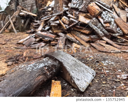 Chopping firewood in a rustic setting during winter's chill Chopping firewood in a rustic setting during winter's chill 135752945