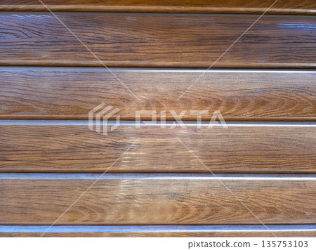 Wooden wall surface with natural wood grain texture. Interior design material. Rough wood pattern. Hardwood plank. Brown background. Wooden wall surface with natural wood grain texture. Interior design material. Rough wood pattern. Hardwood plank. Brown background. 135753103