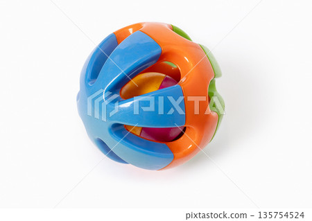 Colorful plastic rattle ball toy for babies and toddlers isolated on white background 135754524