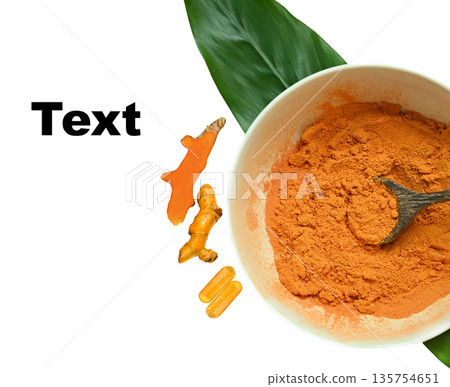 Top view of turmeric powder in a bowl, fresh turmeric root, turmeric capsules, and sliced turmeric arranged with space for text. 135754651