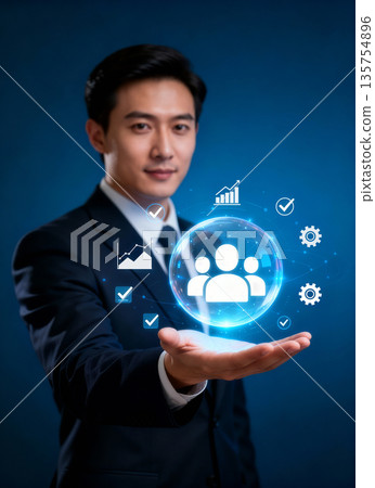 Young businessman in suit holding futuristic hologram of business icons and growth charts, concept of data analysis, management and future digital technology on dark blue background. Young businessman in suit holding futuristic hologram of business icons and growth charts, concept of data analysis, management and future digital technology on dark blue background. 135754896