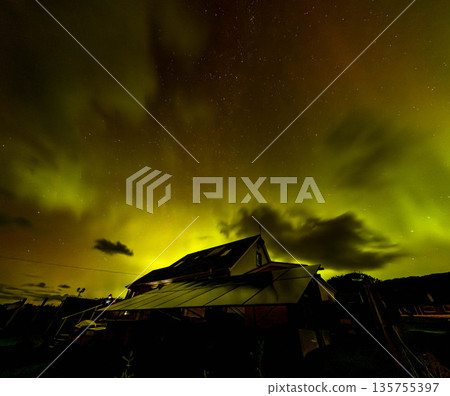 The Aurora Borealis, the northern lights, showing up above bungalow in County Donegal, Ireland The Aurora Borealis, the northern lights, showing up above bungalow in County Donegal, Ireland 135755397