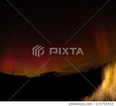 The Aurora Borealis, the northern lights, showing up above bungalow in County Donegal, Ireland The Aurora Borealis, the northern lights, showing up above bungalow in County Donegal, Ireland 135755433