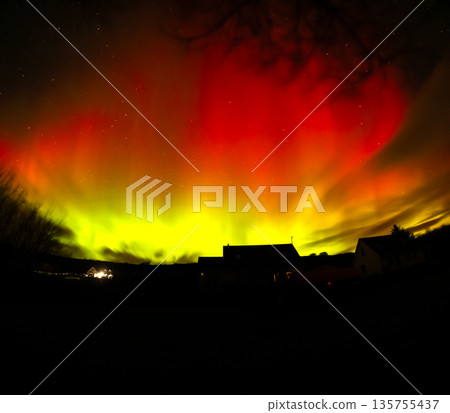 The Aurora Borealis, the northern lights, showing up above bungalow in County Donegal, Ireland 135755437