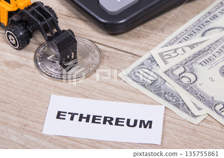 Ethereum coin, dollar bills, miniature excavator and calculator Ethereum coin, dollar bills, miniature excavator and calculator 135755861