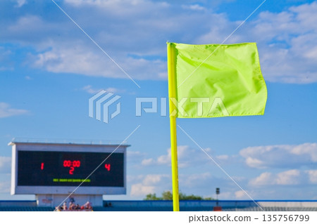 STADIUM - Football field with corner flag and tablo on blue sky 135756799