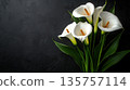 Beautiful bouquet of white calla lilies against a textured black background. Funeral symbol 135757114