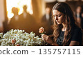Funeral, sad and woman with flower on coffin after loss of loved one, family or friend. A young woman in church surrounded 135757115
