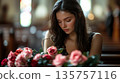 Funeral, sad and woman with flower on coffin after loss of loved one, family or friend. A young woman in church surrounded 135757116