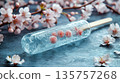 3D rendering glass transparent ice popsicle cherries frozen inside, placed textured surface surrounded blooming cherry blossoms 135757268