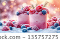 Ice cream scoops in a cup, creatively decorated with berries raspberries, blueberries, forming an artistic and unique concept summer dessert on a pastel pink background. 135757275