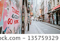 Curvy narrow street with residential buildings and protest graffiti Tourists Go Home, overtourism concept 135759329