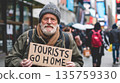 Elderly protester man holds sign with text Tourists Go Home, demonstration against overtourism in touristic european city 135759330